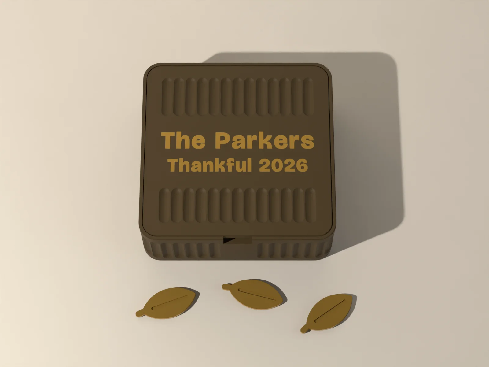 Gratitude box lid from above, the family name inlaid between bands of reeding