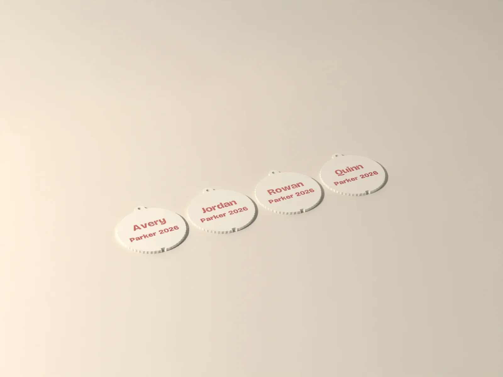 Four ivory ornaments with Avery, Jordan, Rowan and Quinn inlaid in candy red, each with Parker 2026 underneath