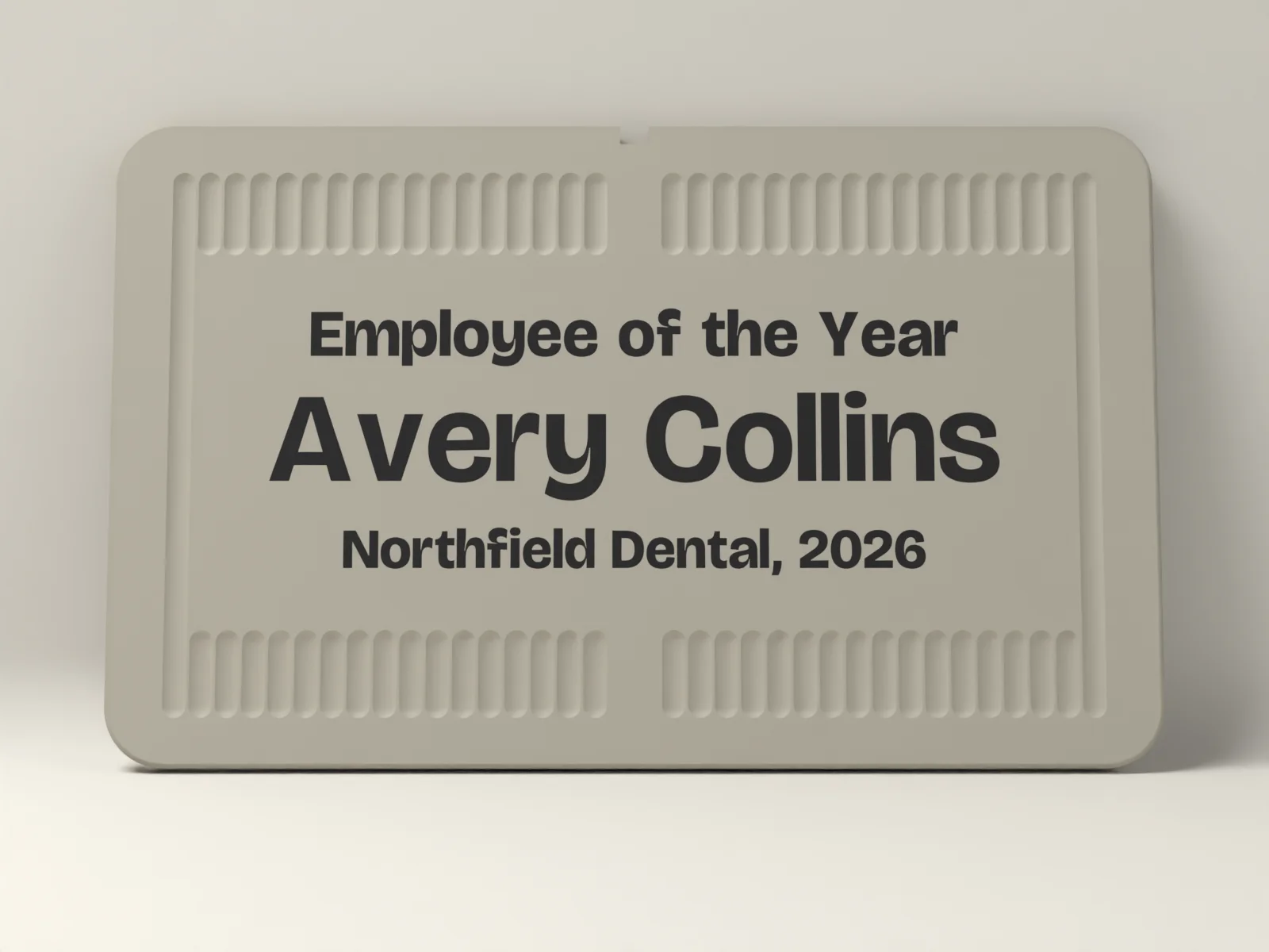 Award plaque from the front, three lines of text inlaid flush in a second color