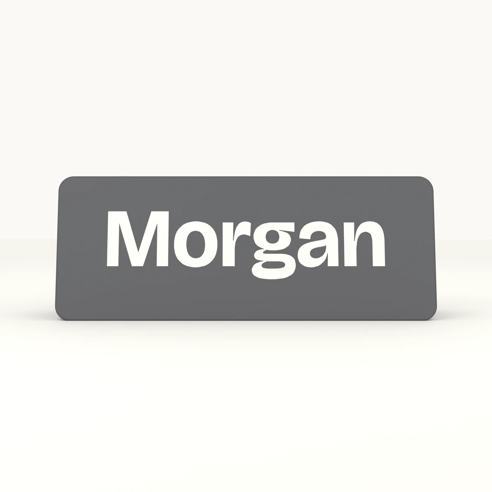 Close view of the raised letters and the twelve degree wedge base of the desk name plaque