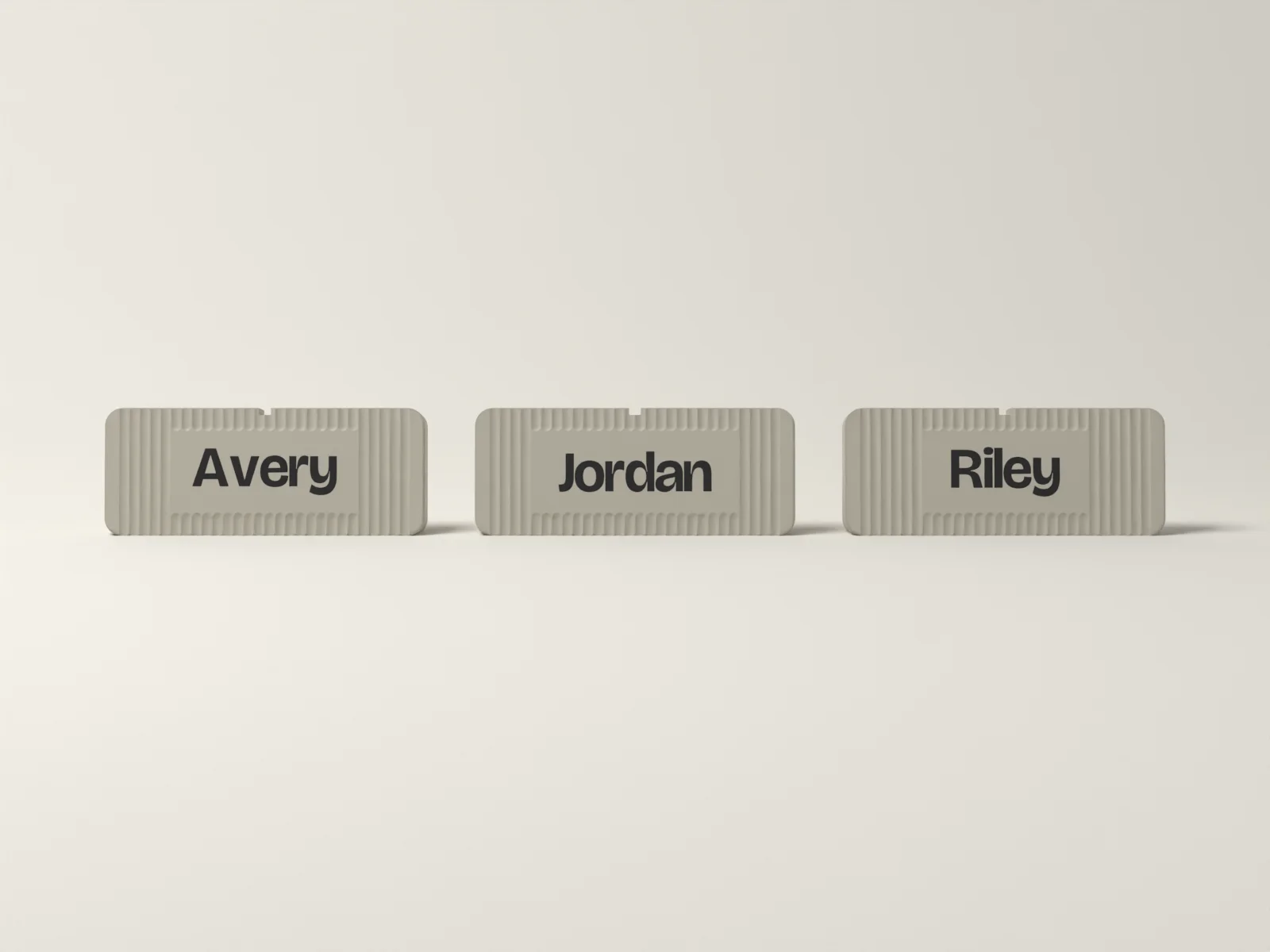 Team desk plates from the front, each sized to its own name