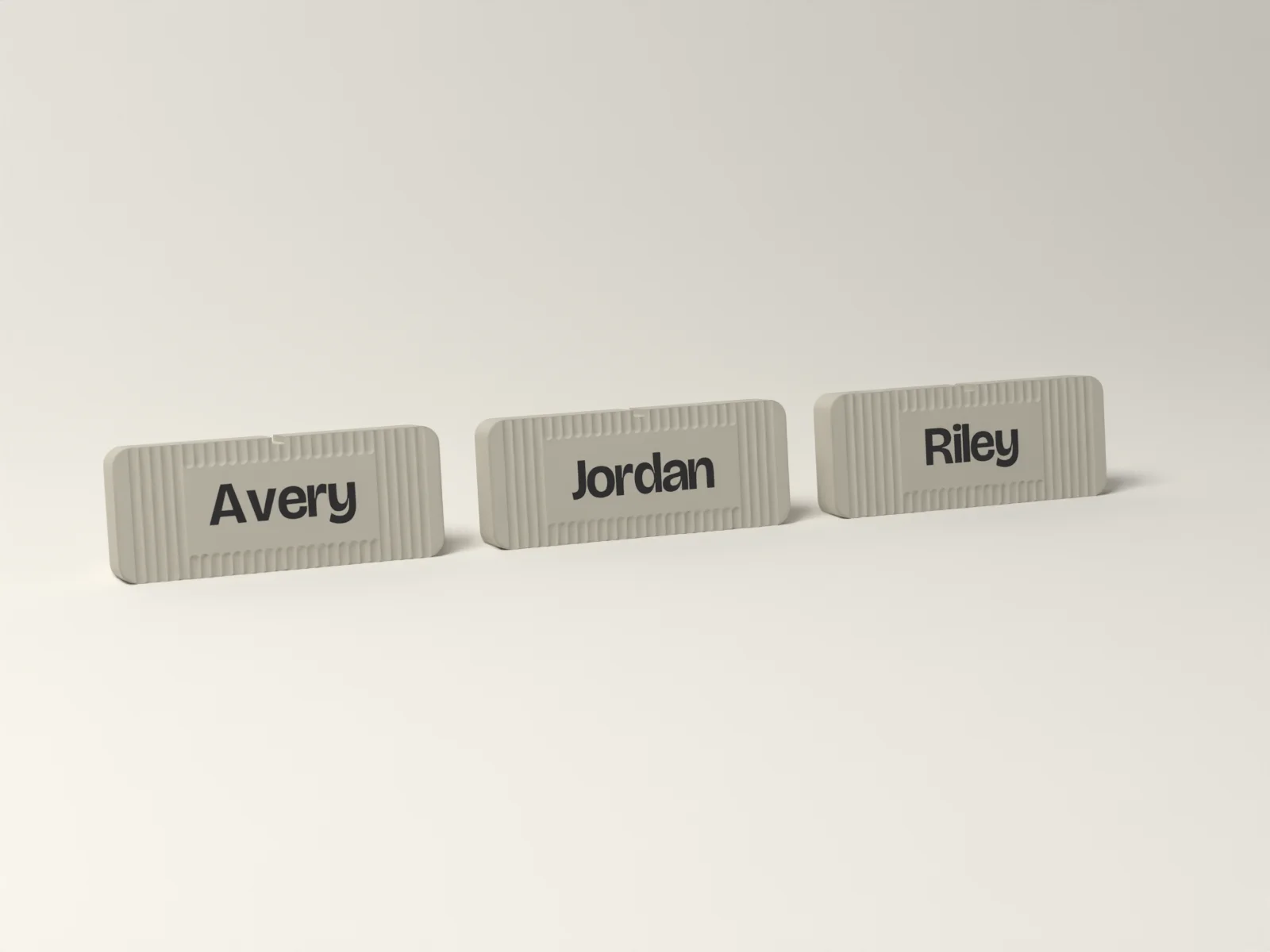 Three Fluted desk name plates in Gallery reading Avery, Jordan and Riley, from a five plate team pack