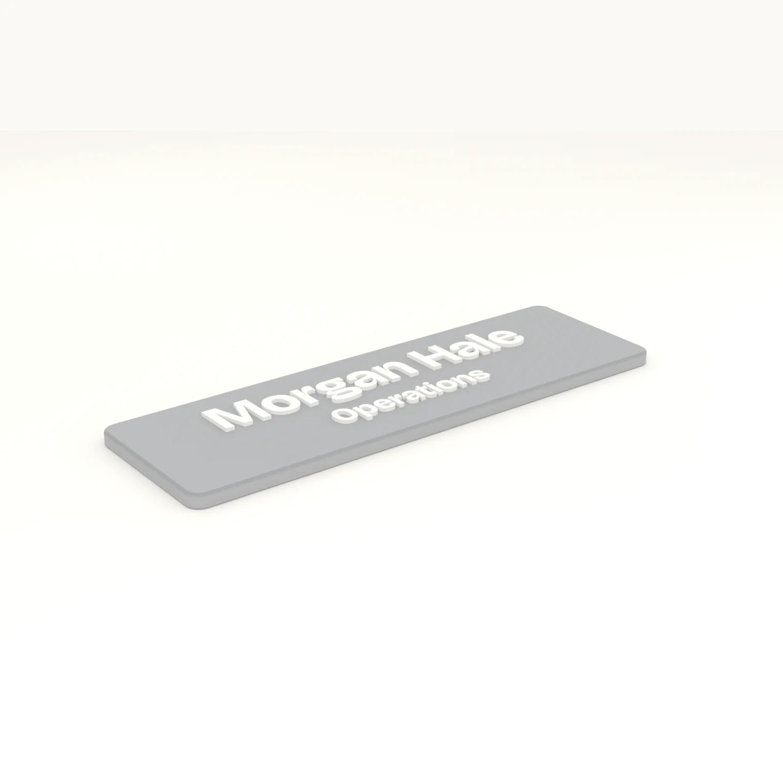 Office door sign in slate grey with a name on the first line and a title on the second in white