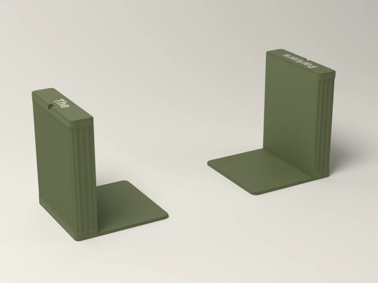 Bookends from above, the words inlaid flush along the top edges and the thin feet that slide under the books
