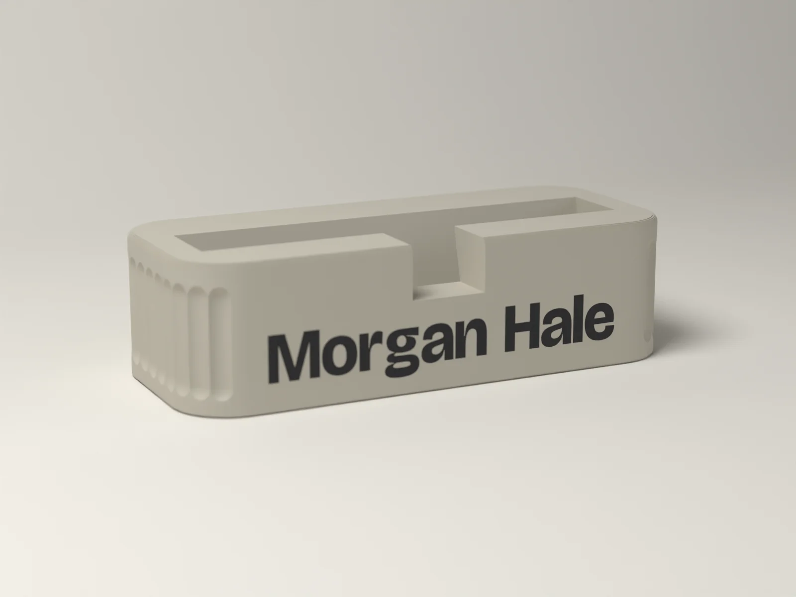 Business card holder from the front, the name on a smooth panel between fine flutes