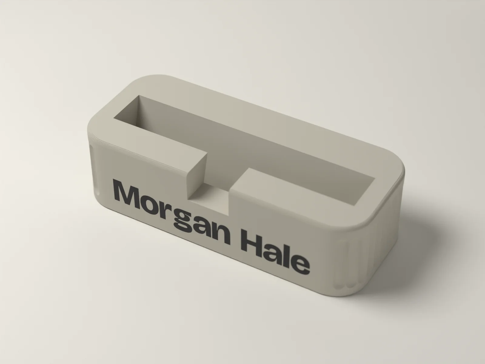 Business card holder from above, showing the leaning card pocket and the square thumb notch