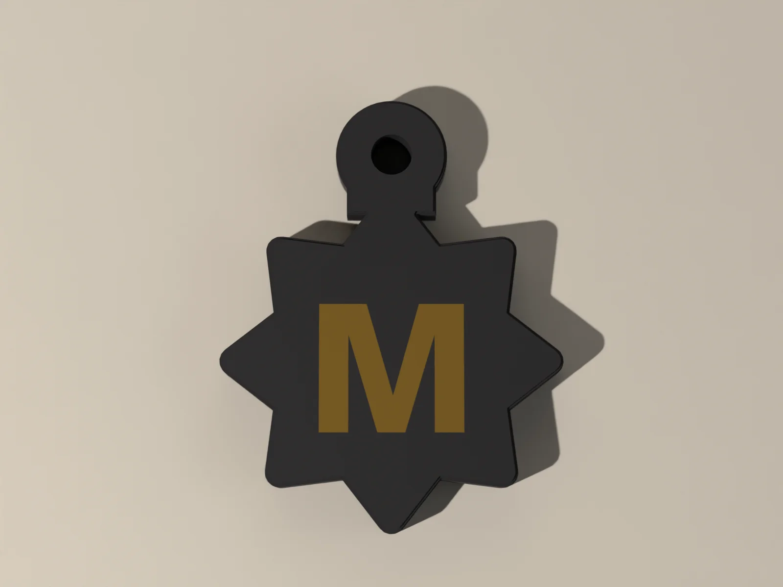Keyed charm from the front, the star outline and the gold initial