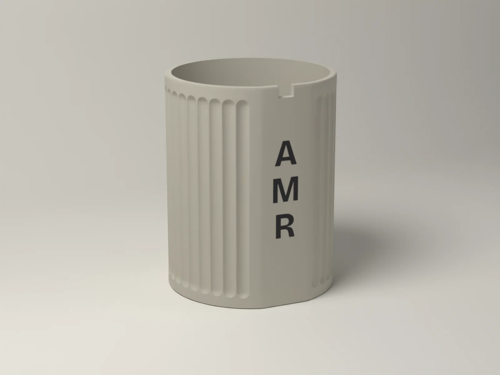 Fluted pen cup, three quarter view, showing the bold flutes and the stacked monogram