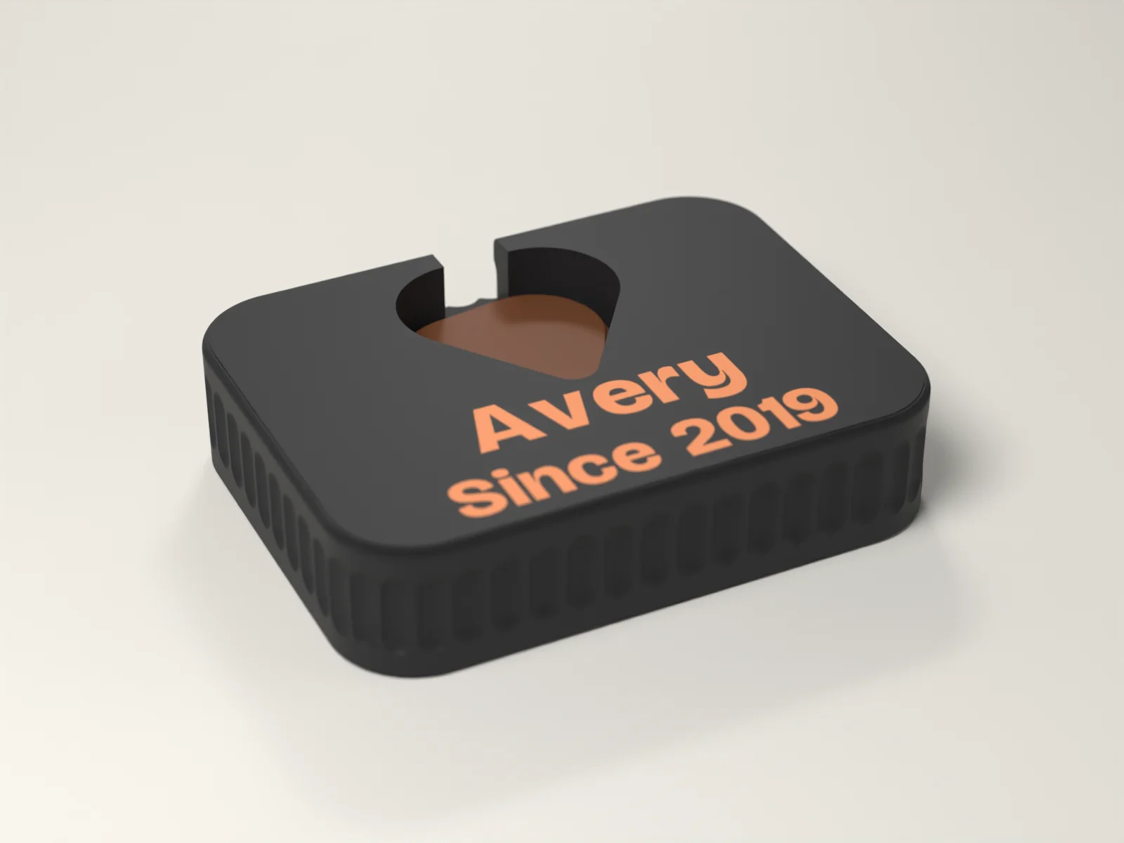 Guitar pick holder in Ink with a pick shaped well holding a stack of picks and Avery and Since 2019 inlaid flush in Ember