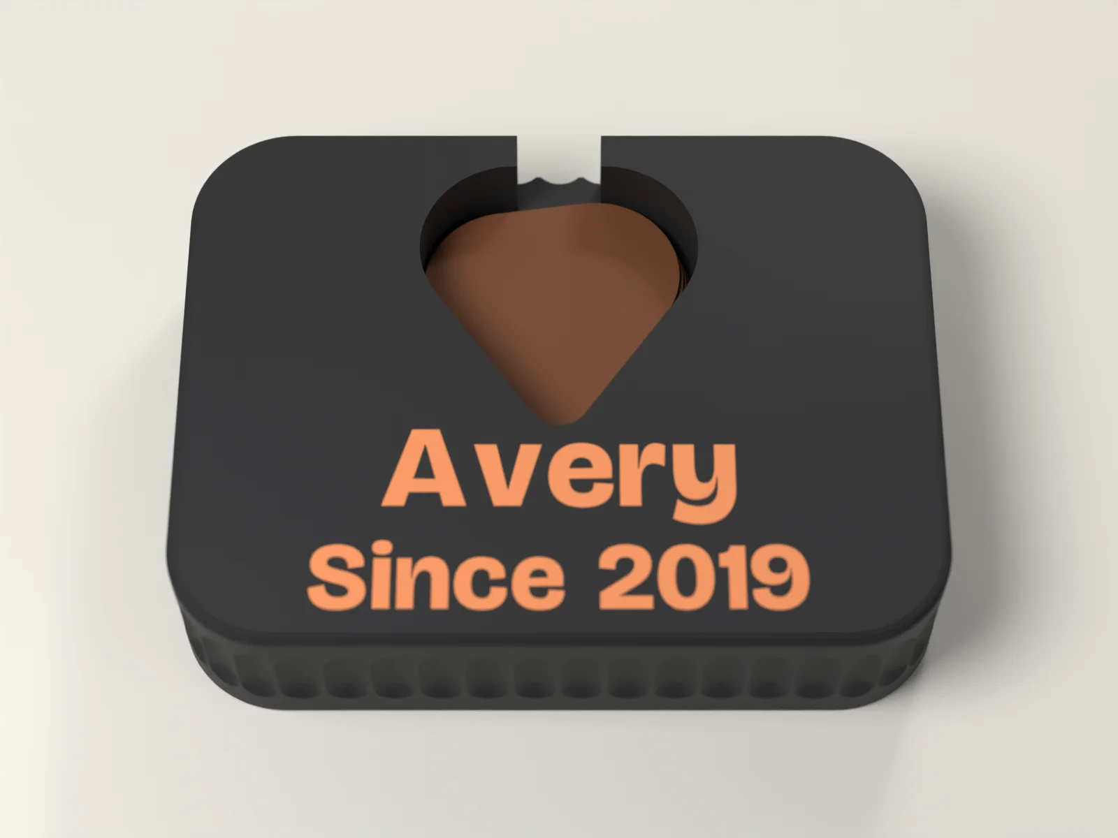 Guitar pick holder from above, the pick shaped well and the name in front of it