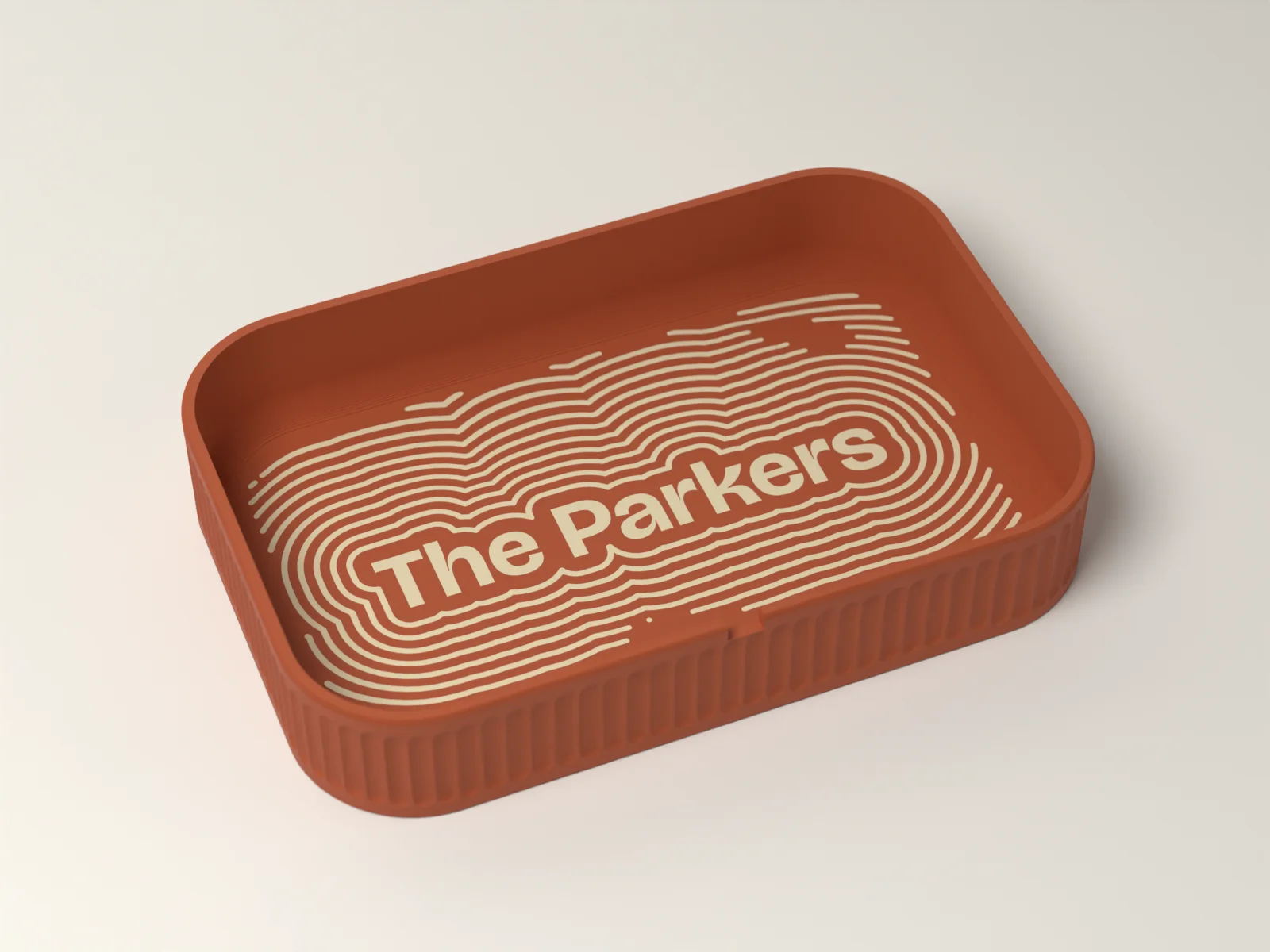 Personalized valet tray in Terracotta with The Parkers inlaid in Sand as the summit of a contour map in the floor