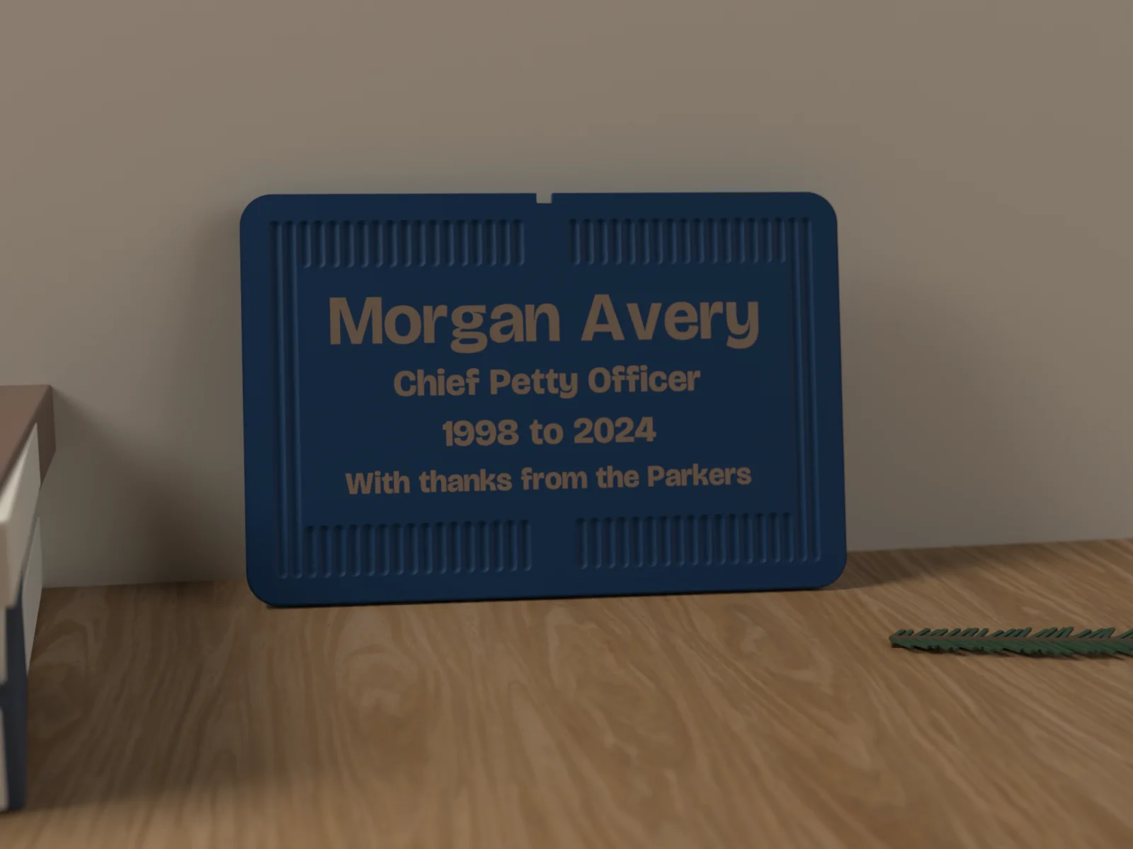 Service plaque on a walnut shelf beside a folded flag and a pair of books
