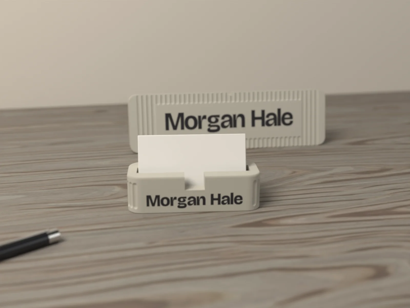 Business card holder beside the desk name plate on a desk