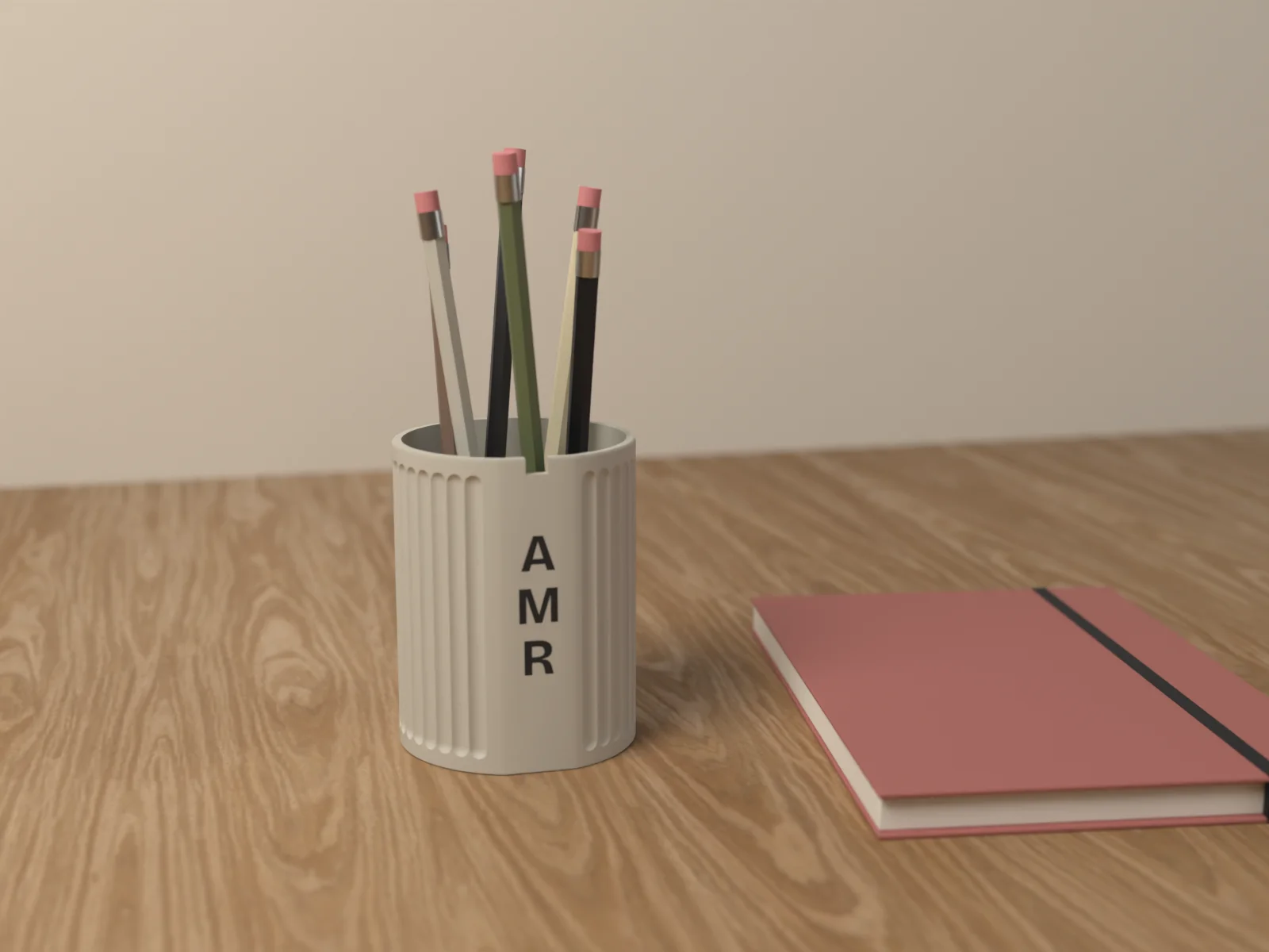 Fluted pen cup holding pencils and a brush on a desk